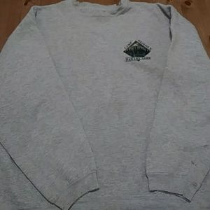 Sweater with small design on left side when worn